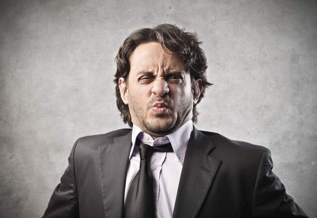 17254729-ortrait-of-businessman-disgusted-on-a-gray-background-640x0