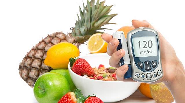 Diabetes concept glucose meter in hand and healthy organic food, lemon, pear, apples, fresh orange, pineapple and breakfast cereal muesli bowl on a white background